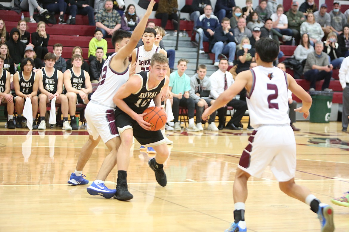 Gunnar Andersen (10) of Royal High School looks to pass the ball between Orlando Nunez (23) and Arnoldo Ramos (2) in a league game at Wahluke High School on Friday.