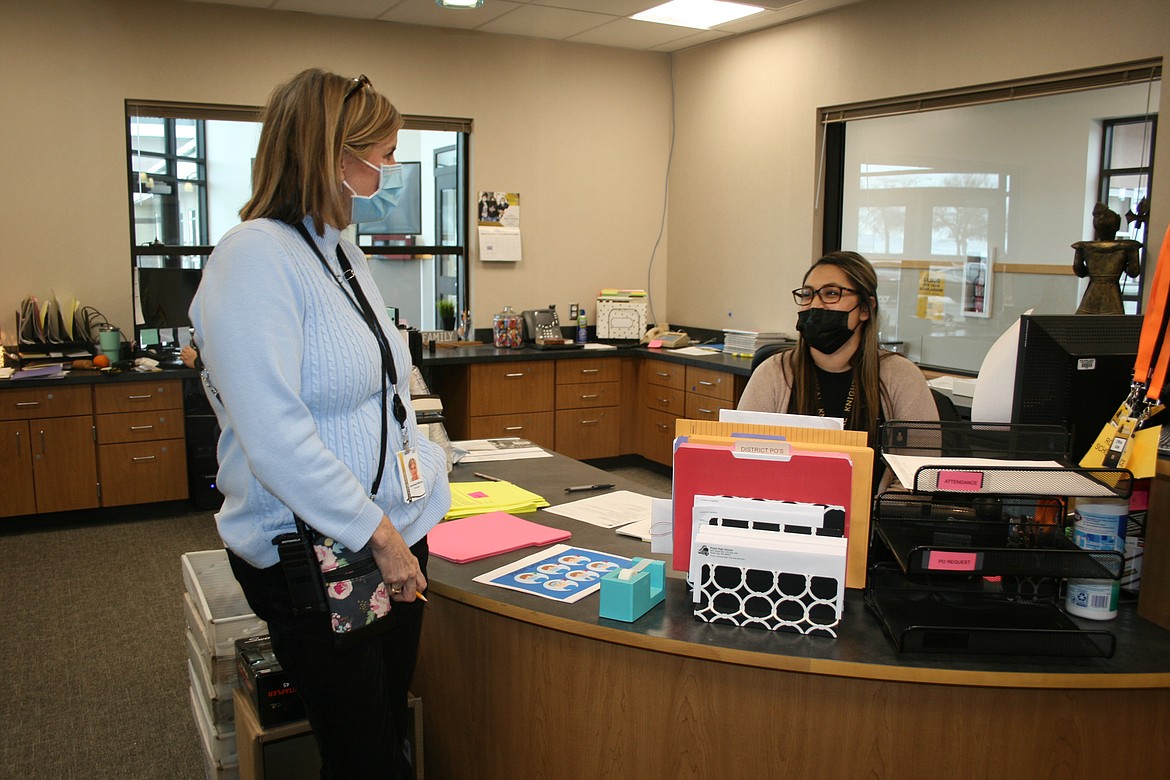 Courtney McCoy, left, the Royal High School principal, talks with lead secretary Vanessa Rodriguez, right, in the new RHS office on Thursday.