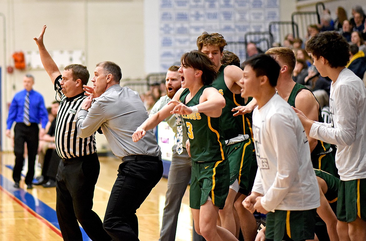 Whitefish players and coaches erupt in excitement as the Bulldogs nailed a 3-pointer to cut Columbia Falls' lead in the fourth quarter on Saturday. (Whitney England/Whitefish Pilot)