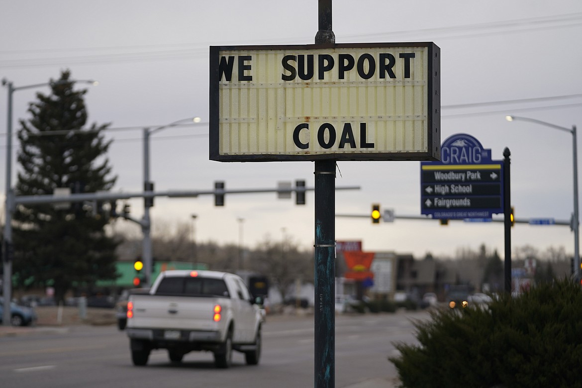 A sign displays support for the coal industry Friday, Nov. 19, 2021, in Craig, Colo. The town in northwest Colorado is losing its coal plant, and residents fear it is the beginning of the end for their community. (AP Photo/Rick Bowmer)