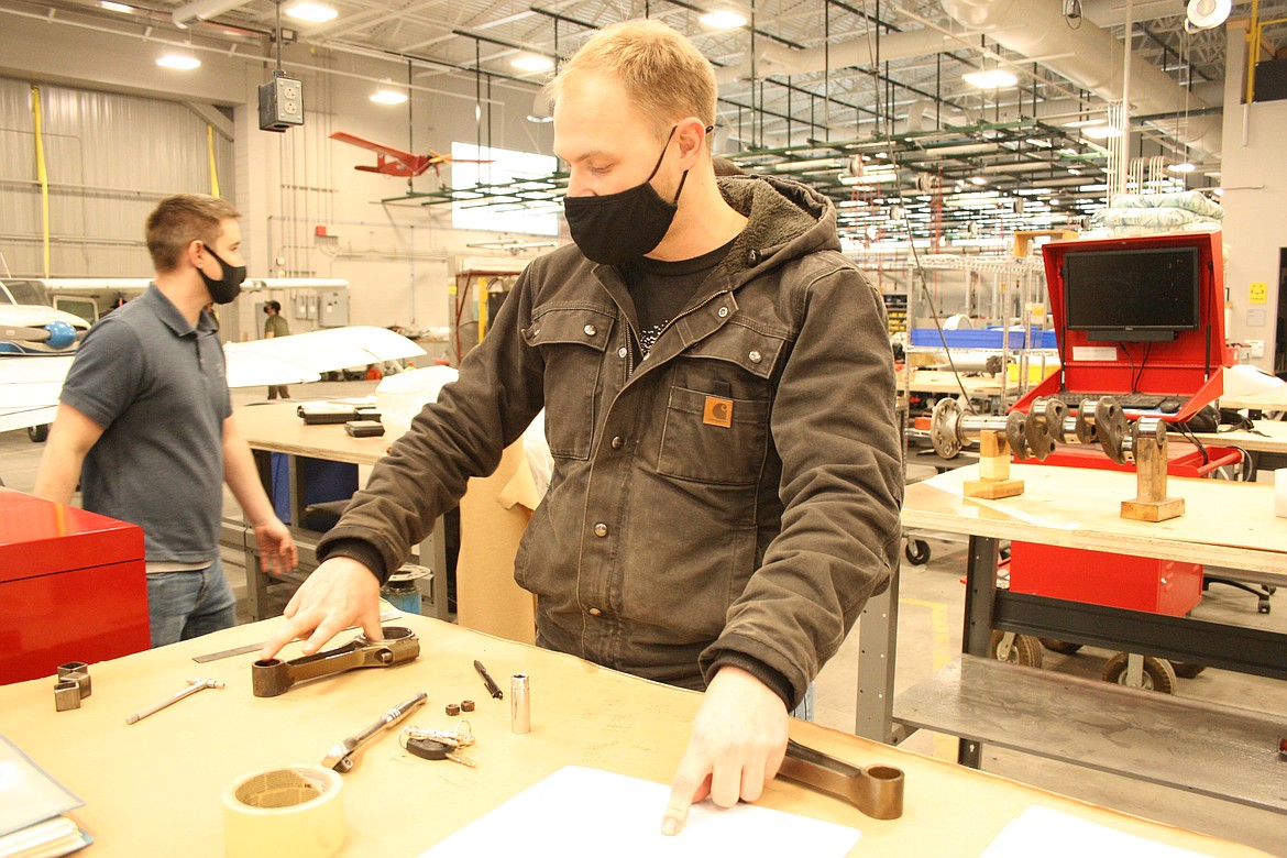 Corey Tyron writes down the specs for an aircraft engine connecting rod during aviation maintenance technology class at Big Bend Community College on Wednesday.