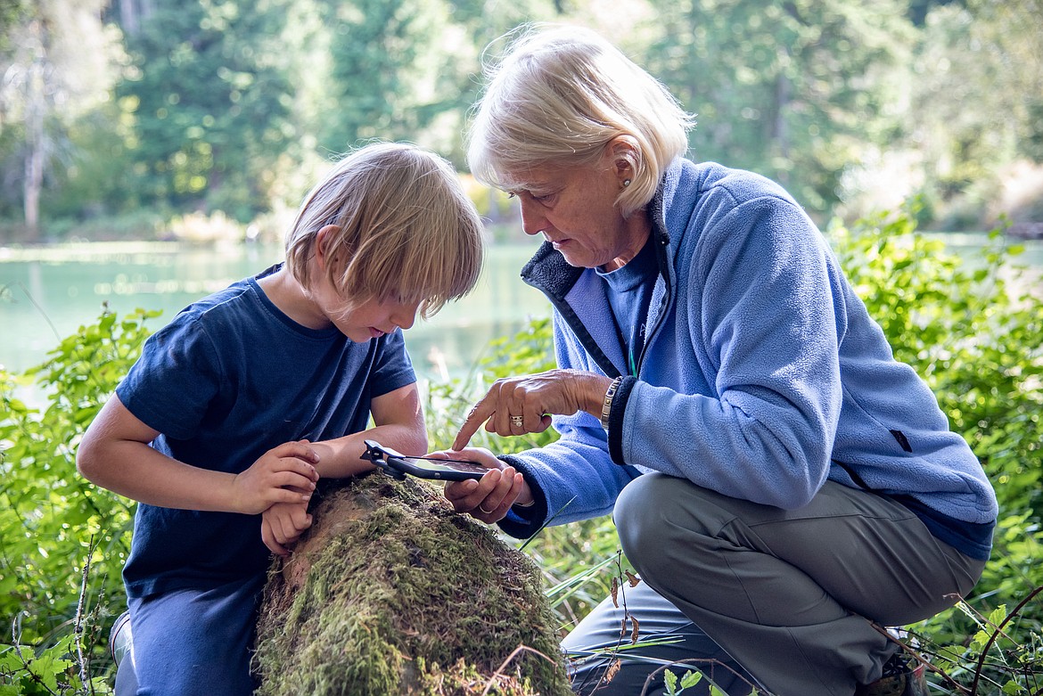 A grandmother explores nature with her grandson using the Exploring Biodiversity Kit.  Photo credit: Emily Maletz