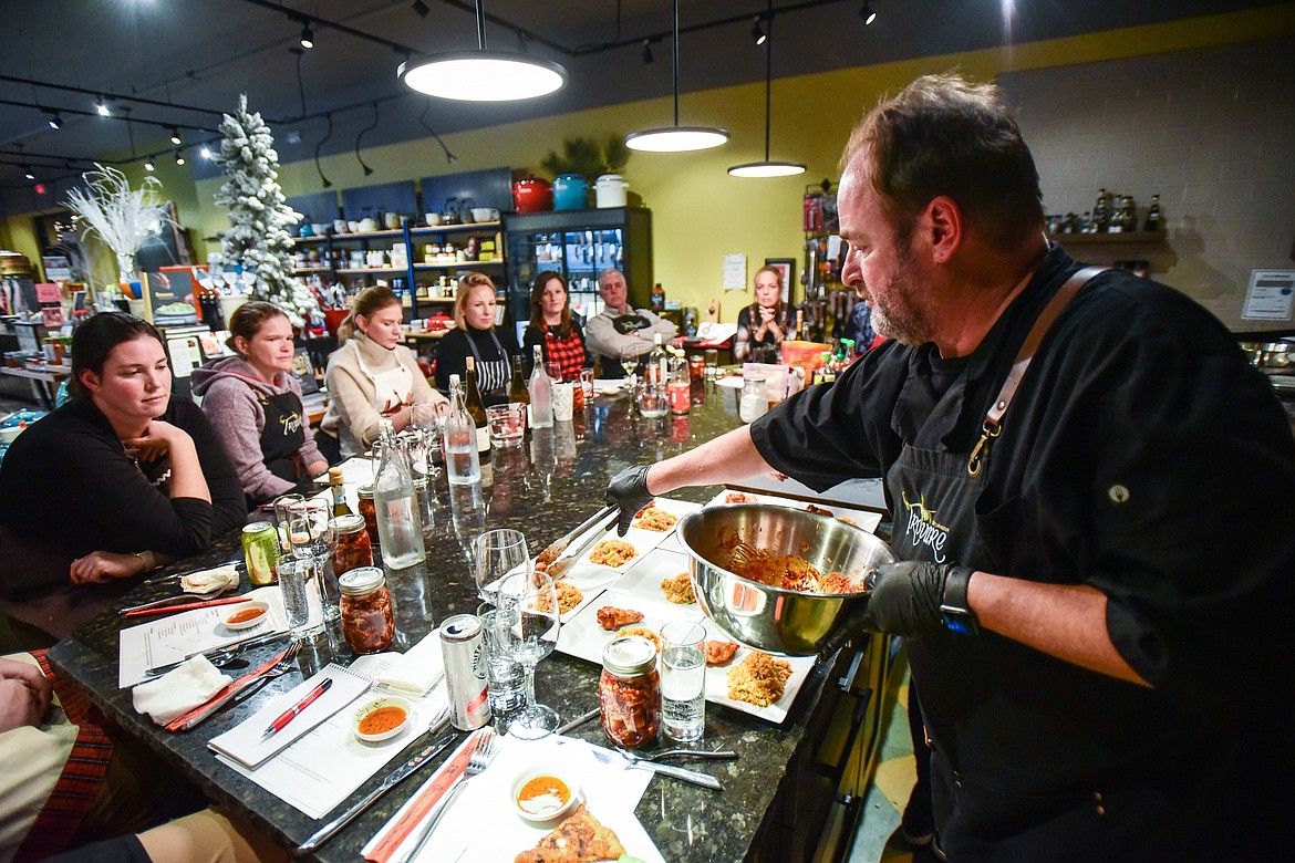 Chef John Evenhuis plates Kimchi Fried Rice & Korean Chicken Wings for attendees during a hands-on cooking class at Trovare in Whitefish on Tuesday, Jan. 18. (Casey Kreider/Daily Inter Lake)