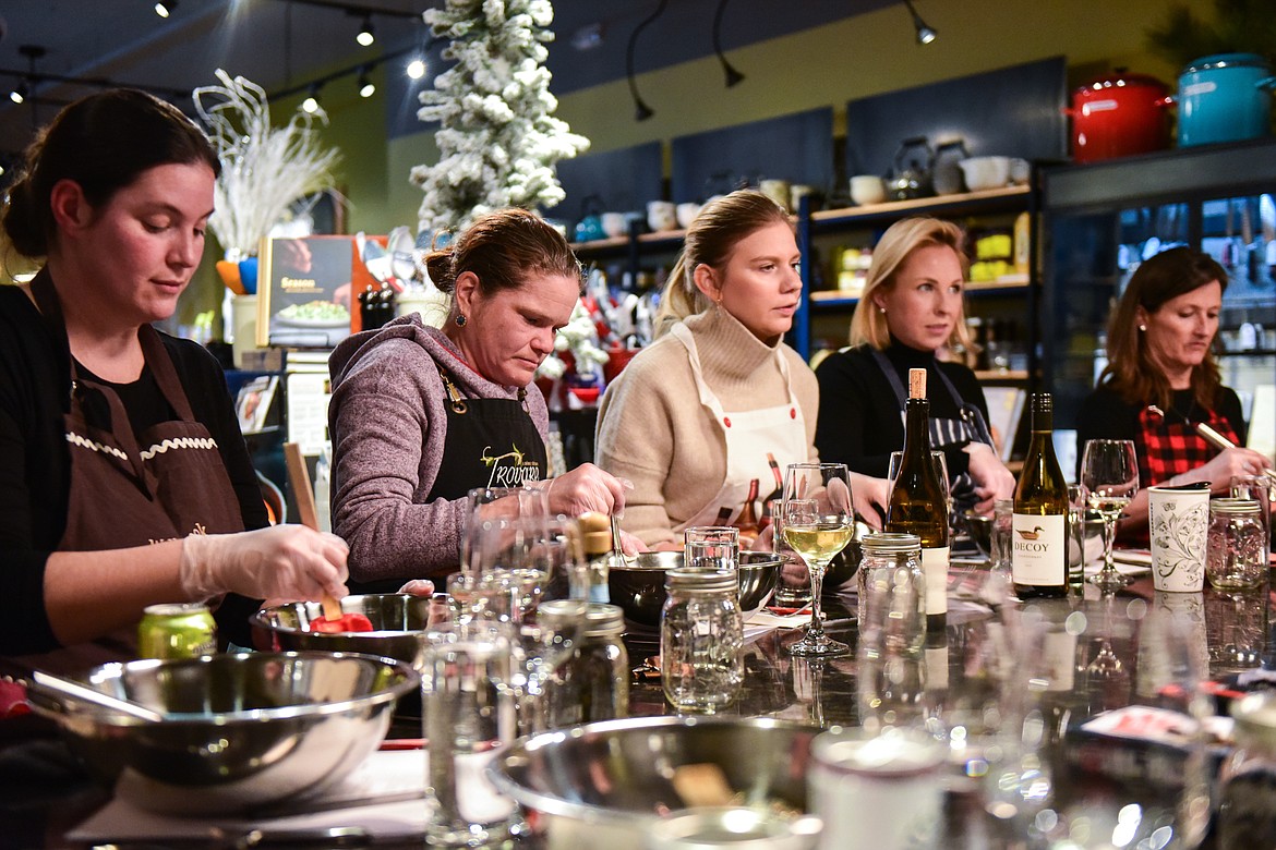 Attendees mix ingredients for kimchi during a hands-on cooking class with chef John Evenhuis at Trovare in Whitefish on Tuesday, Jan. 18. (Casey Kreider/Daily Inter Lake)