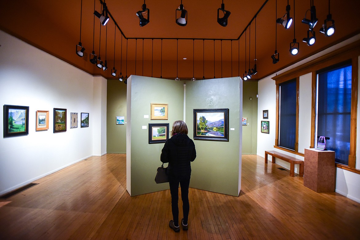 Pamela Ryan looks at artwork in the Members' Salon 2022 exhibit at the Hockaday Museum of Art in Kalispell on Thursday, Jan. 20. Museum members of all ages and skill levels show recent work together in this annual exhibition. Visual arts of all styles and mediums are on display. (Casey Kreider/Daily Inter Lake)