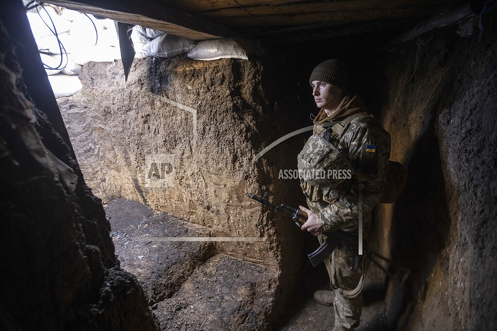 An Ukrainian soldier stands in the trench on the line of separation from pro-Russian rebels, in Mariupol, Donetsk region, Ukraine, Thursday, Jan. 20, 2022. President Joe Biden has warned Russia's Vladimir Putin that the U.S. could impose new sanctions against Russia if it takes further military action against Ukraine. U.S. Secretary of State Antony Blinken is warning of a unified, "swift, severe" response from the United States and its allies if Russia sends any military forces into Ukraine. (AP Photo/Andriy Dubchak)