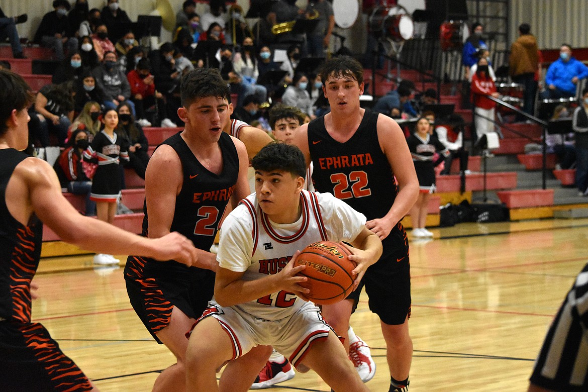 Othello High School sophomore Michael Vallejo (12) has possession of the ball while three Ephrata High School opponents surround him during the game on Tuesday at Othello High School.