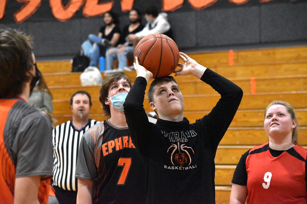 Ephrata High School senior Ethan Black (24) drives the ball down court as Othello High School senior Jorge Buenrostro (24) follows closely.