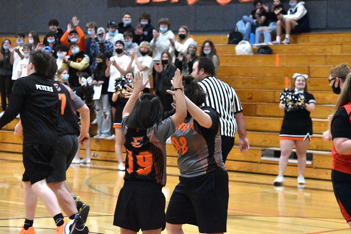 Bertha Rodriguez (19) and Emily Williams (88) high five after their team scores on Wednesday at the Unified basketball game against Othello High School.