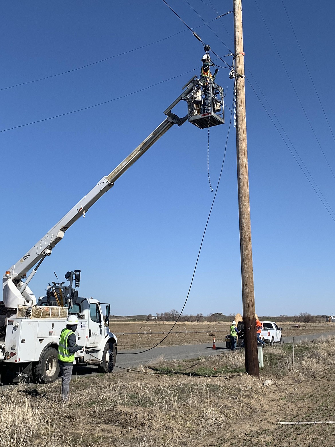 Workers with North Sky Communications install fiber-optic cable.