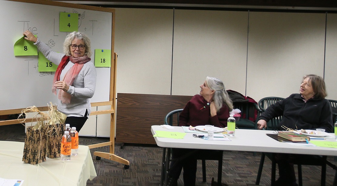 North Idaho Education Association Retired Chapter President Bette Price stands at the whiteboard for an exercise during the book club meeting Wednesday. A book club, an art program, educational activities, volunteer opportunities and more keep these former educators connected and busy in their retirement years.