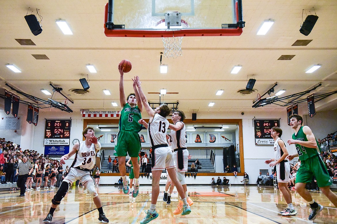 Glacier's Ty Olsen (5) drives to the basket for a layup in the fourth quarter against Flathead at Flathead High School on Friday, Jan. 21. (Casey Kreider/Daily Inter Lake)