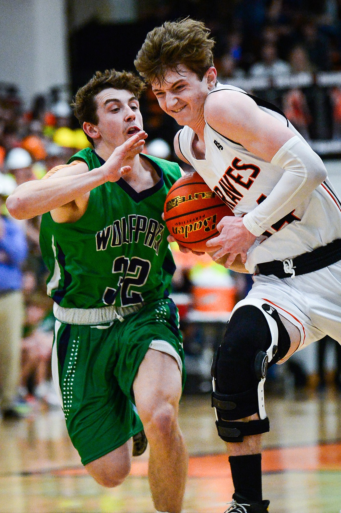 Flathead's Joston Cripe (34) is fouled on his way to the basket by Glacier's Jake Turner (32) at Flathead High School on Friday, Jan. 21. (Casey Kreider/Daily Inter Lake)