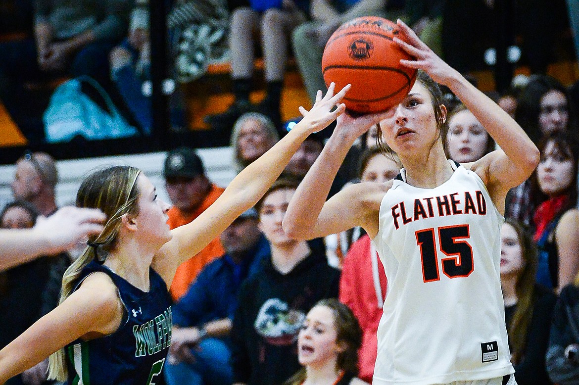 Flathead's Clare Converse (15) shoots a three-pointer guarded by Glacier's Kiera Sullivan (5) at Flathead High School on Friday, Jan. 21. (Casey Kreider/Daily Inter Lake)