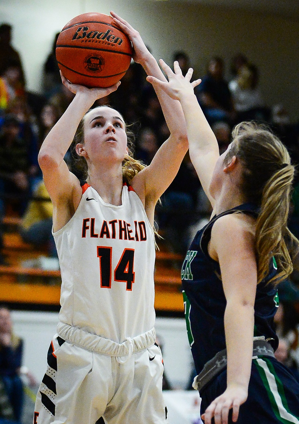 Flathead's Kennedy Moore (14) shoots over Glacier's Sarah Downs (3) at Flathead High School on Friday, Jan. 21. (Casey Kreider/Daily Inter Lake)