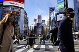 Japan widens virus restrictions as omicron surges in cities