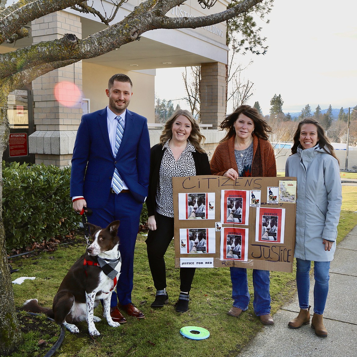 From left, Christian Harlocker, Jade Harlocker, Pennie Collinson and Ashley Craig stand outside the courthouse with border collie Reddington. The dog, owned by the Harlockers, had an eye removed after he was shot with a metal pellet gun at close range on June 19. Friday's sentencing for the neighbor who pleaded guilty in November has been postponed. HANNAH NEFF/Press