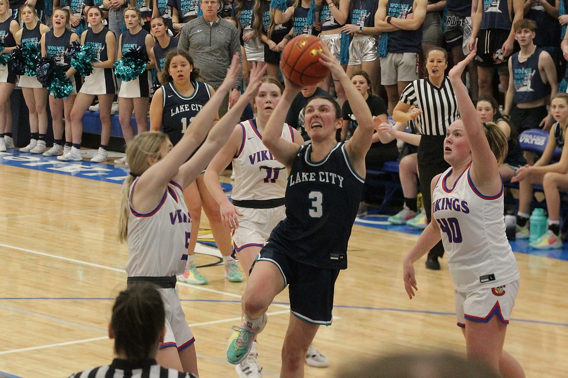 MARK NELKE/Press
Allie Bowman (3) of Lake City drives to the basket as Libby Awbery (5) and Kendall Holecek (40) of Coeur d'Alene defend on Friday night at Viking Court.