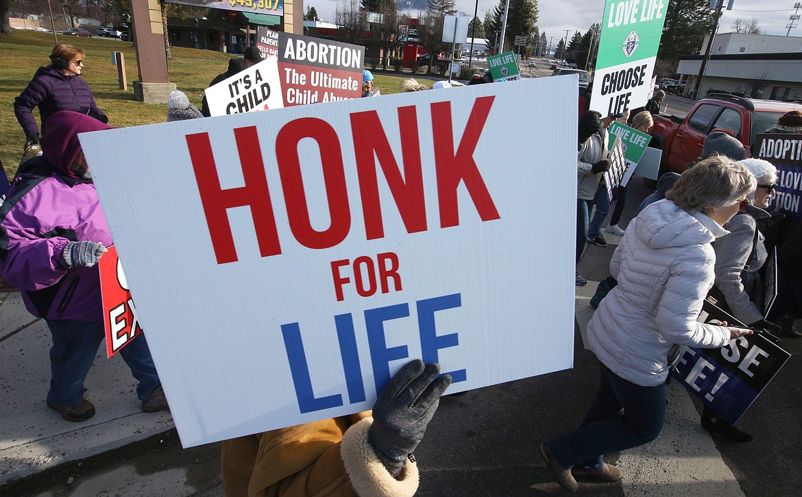 A sign is held high during the Coeur d'Alene Right to Life March and Rally on Saturday.