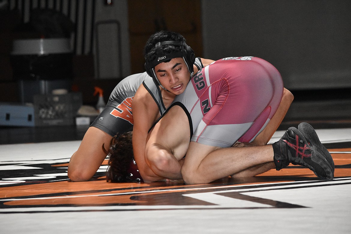 Ephrata High School senior Josue Sanchez works to pin his Grandview High School opponent on Thursday at Ephrata High School.