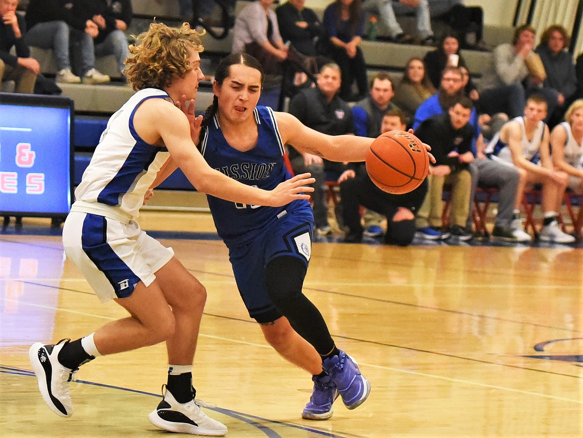 Mission's Jadence Peone drives toward the basket against Bigfork. (Scot Heisel/Lake County Leader)