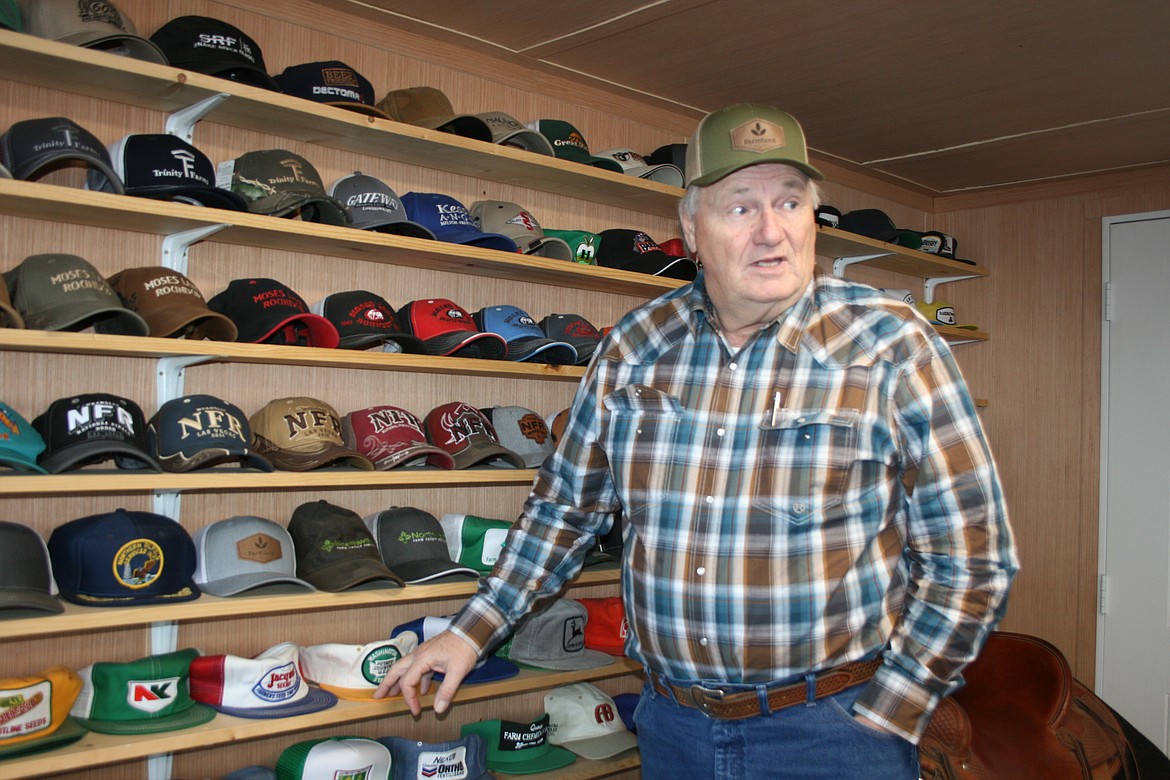 Mike Cobb, of Moses Lake, discusses his hat collection with a visitor on Friday.
