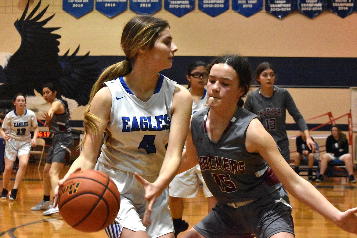 Soap Lake High School freshman Serenity Curtis (4) takes the ball to the hoop while a Waterville/Mansfield High School opponent guards her during the game on Friday.