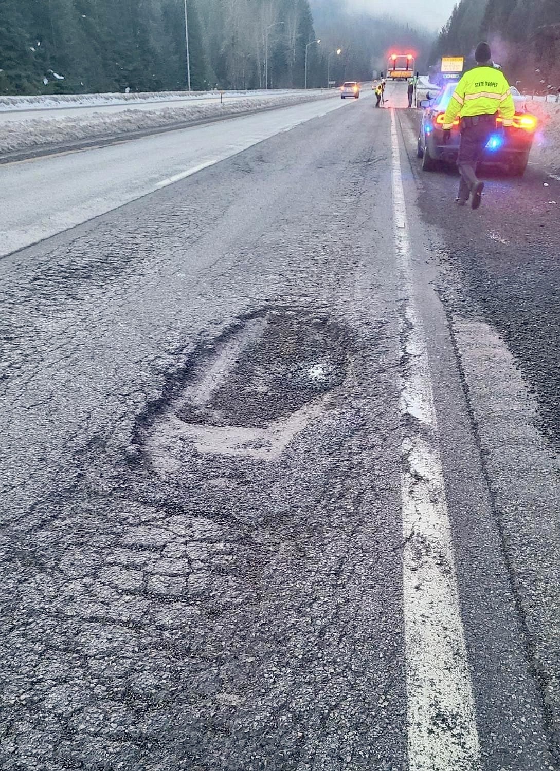 Idaho State Police respond to the I-90 closure at milepost 33 on Jan. 16 after a vehicle crossed into the work zone and crashed into a loader that was being used to fill potholes.