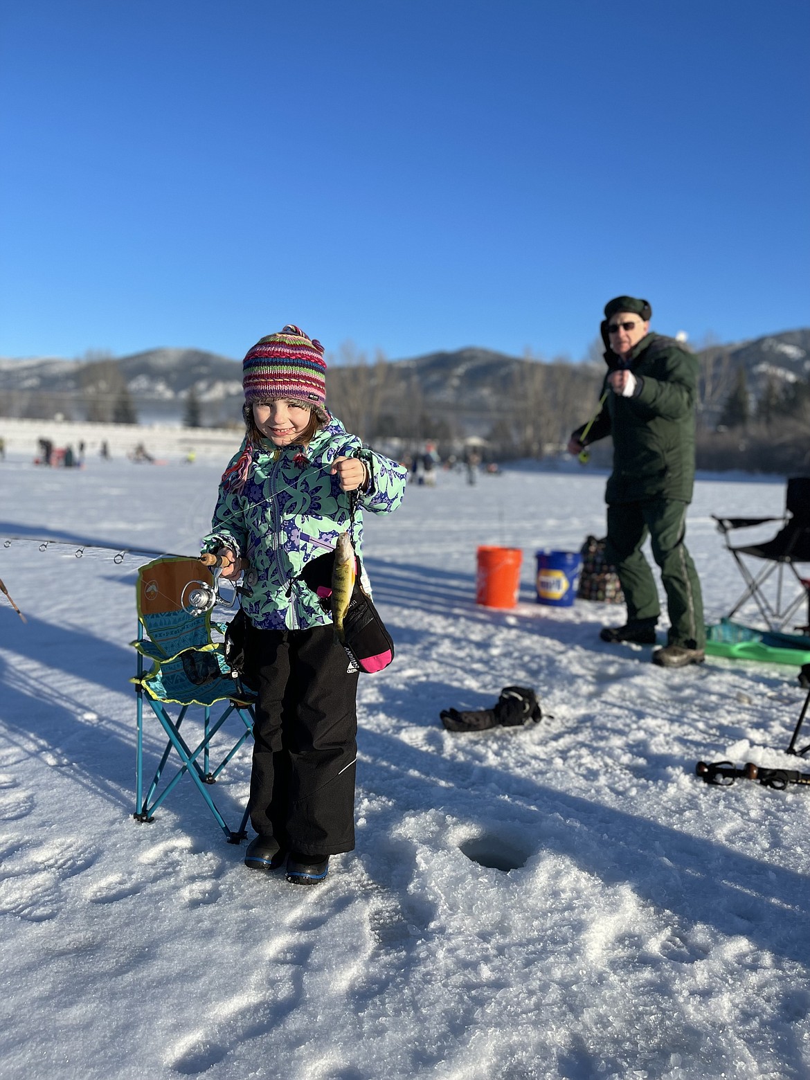 Penelope Tomascak with her grandpa Walt Tomascak from Frenchtown were delighted to be catching perch on Saturday during the annual Kids Fishing Clinic on Frenchtown Pond. The event is sponsored by Youth in the Outdoors each year with over 150 kids participating. (Picture by Kathy Salisbury)