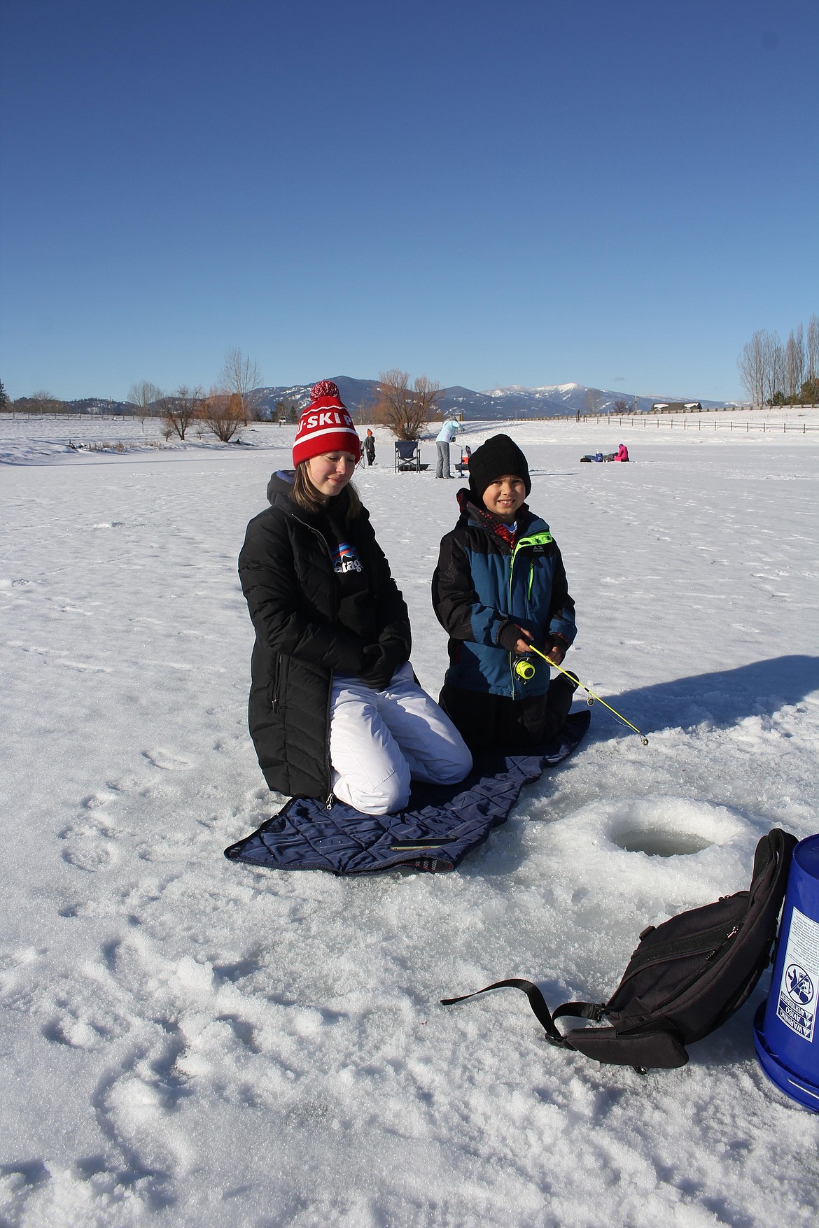 Dylan Connor, 8, and his mom Sandra, drove from St. Regis to participate in the annual Kids Fishing Clinic on Frenchtown Pond last Saturday. They were the first in line to register at 8am with the event starting at 9 and closing at 1. Over 150 kids participated. (Monte Turner/Mineral Independent)