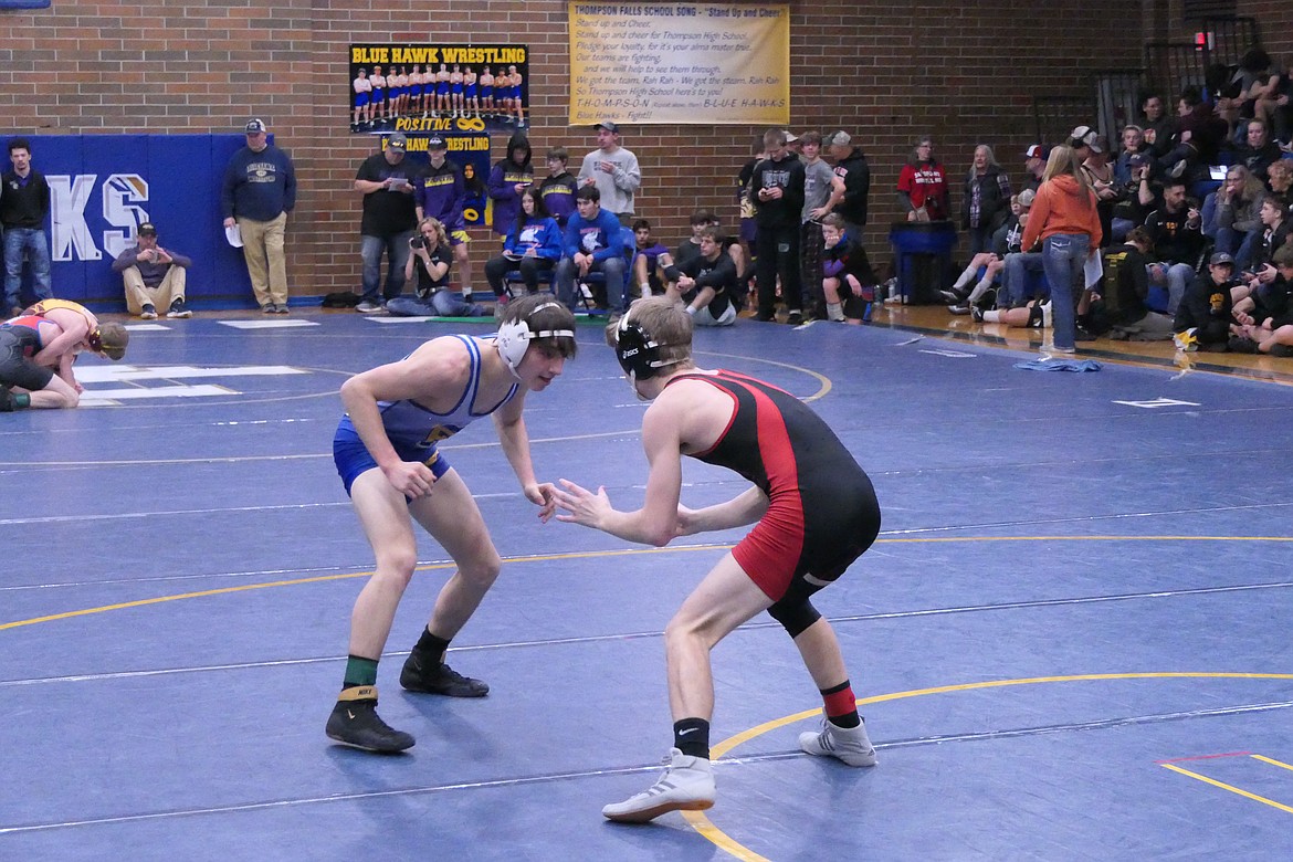 Thompson Falls 126-pounder Westin Brown (blue) faces off with an opponent at the Ted Kato tourney in Thompson Falls Saturday. (Chuck Bandel/Valley Press)