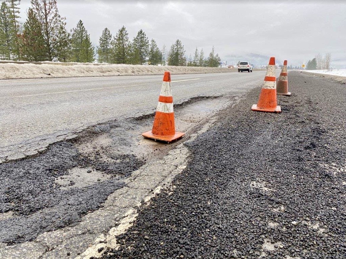 The Idaho Transportation Department sets up cones around the damaged area of Interstate 90 near milepost 48 to guide drivers into the left lane.