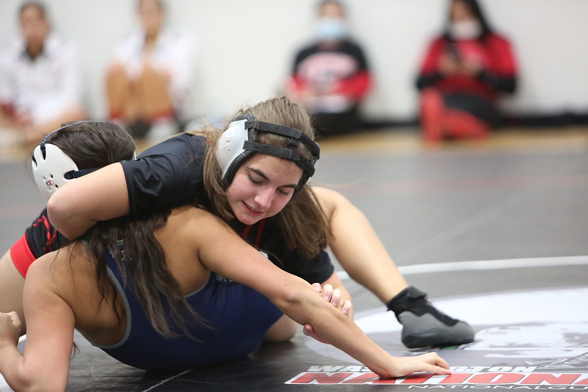 Lucy Giles of Othello High School (top) works to pin Naomi Madrid of Chiawana High School during the Lady Huskies invitational wrestling tournament Friday.