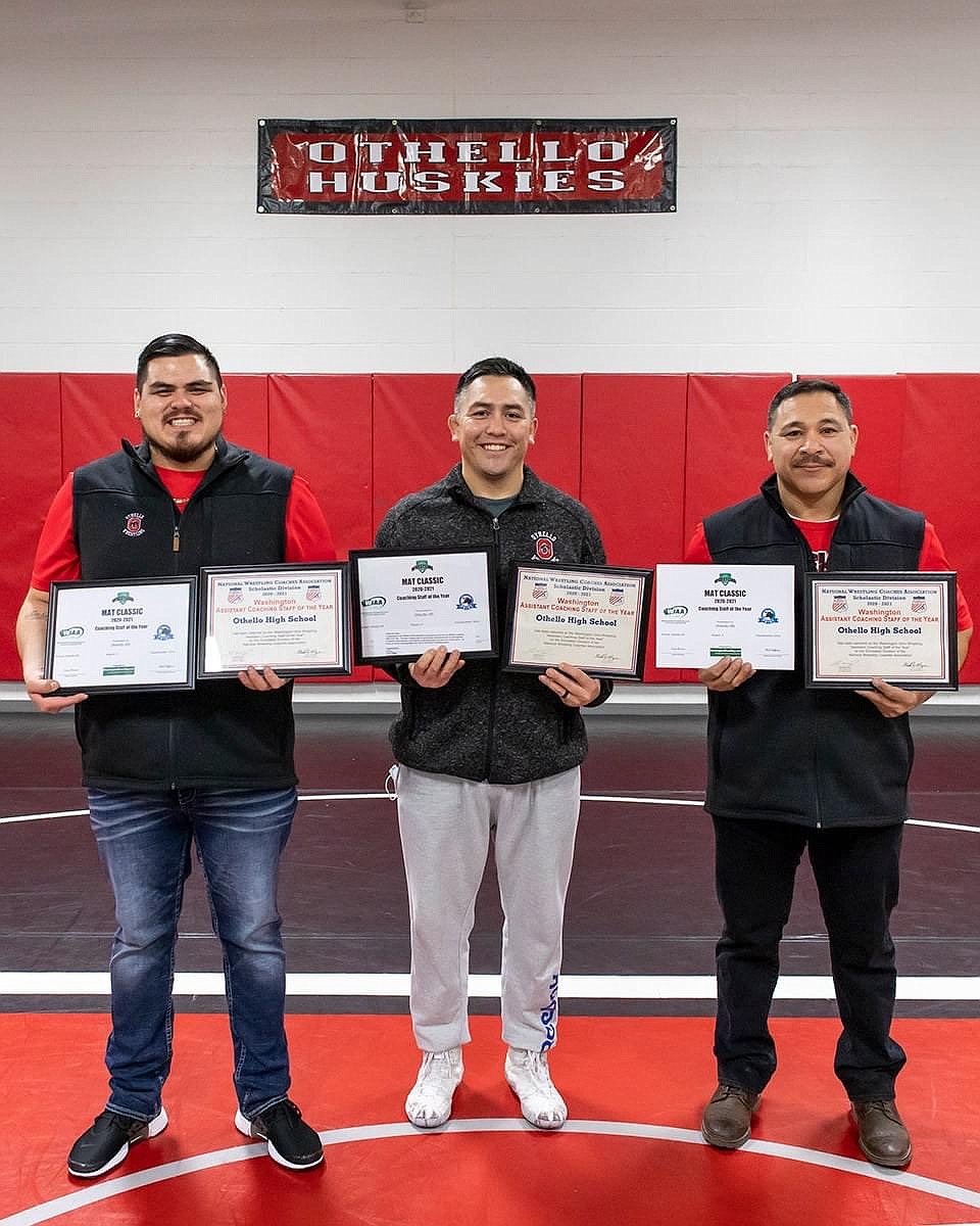 Othello HIgh School girls wrestling coaches (from left) Mark De La Rosa, Rafael Ruiz and Lupe Perez display awards they received from the National Wrestling Coaches Association and the National Assistant Wrestling Coaches Association.