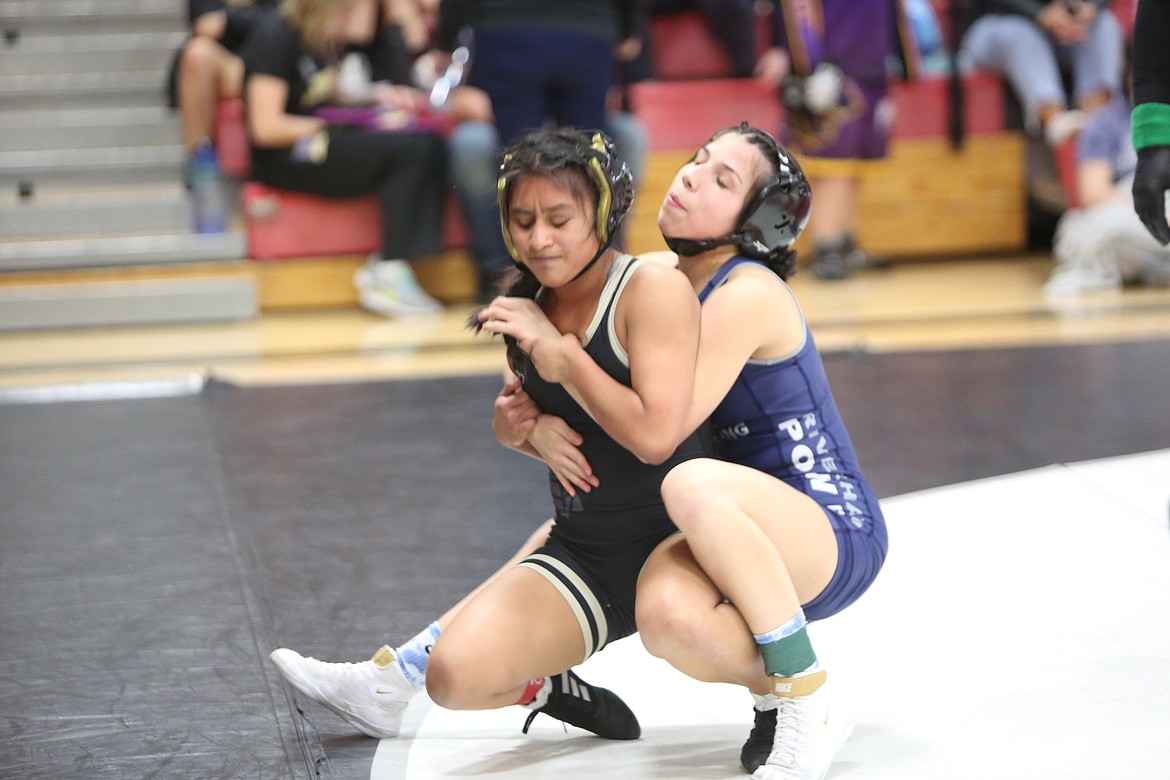 Gisell Delos Santos of Royal High School attempts to escape from Sierra Gonzales of Chiawana High School during the Lady Huskies invitational girls wrestling tournament on Friday.