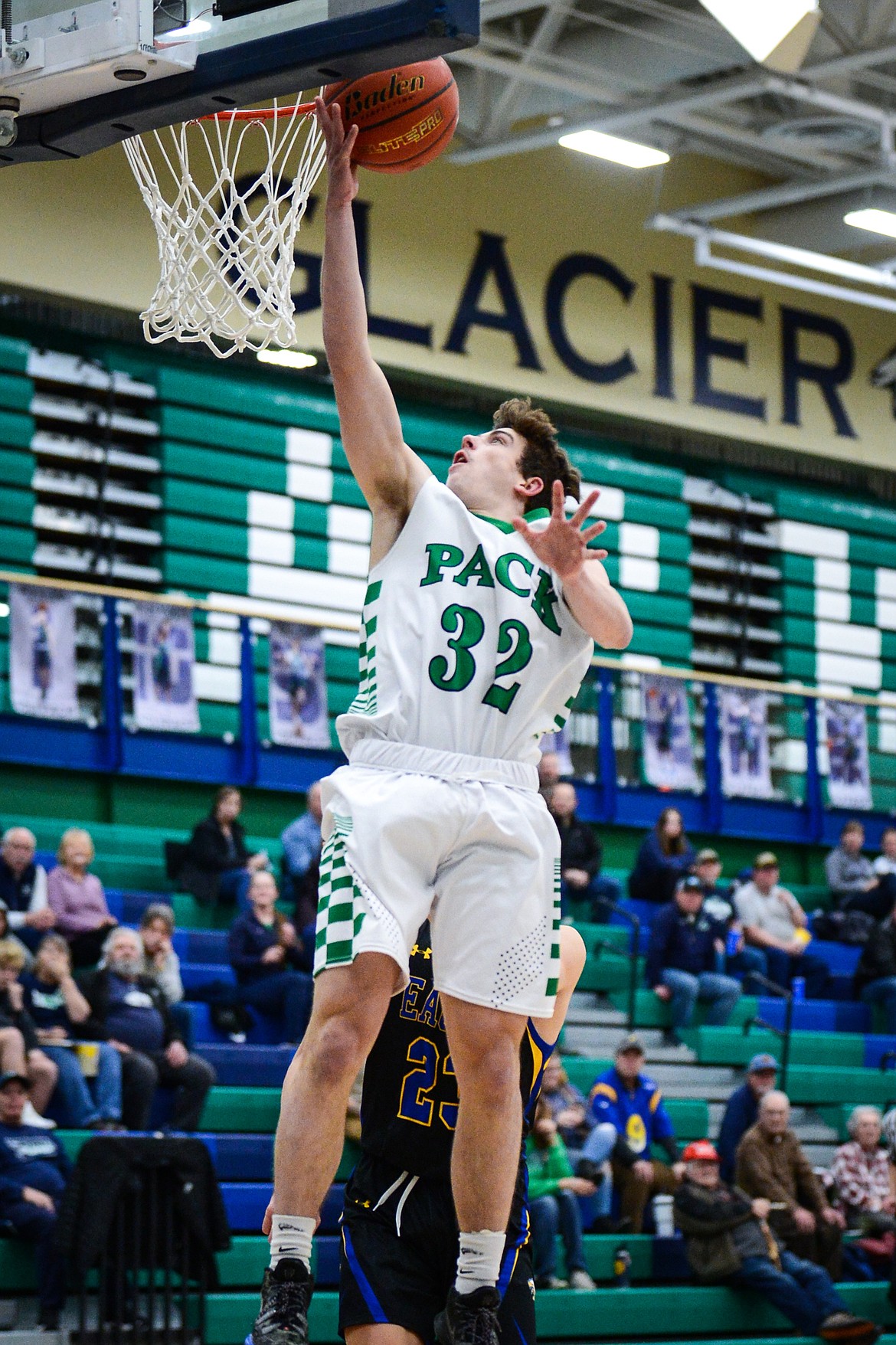 Glacier's Jake Turner (32) lays in two points ahead of Missoula Big Sky's Josiah Cuaresma (23) at Glacier High School on Tuesday, Jan. 25. (Casey Kreider/Daily Inter Lake)