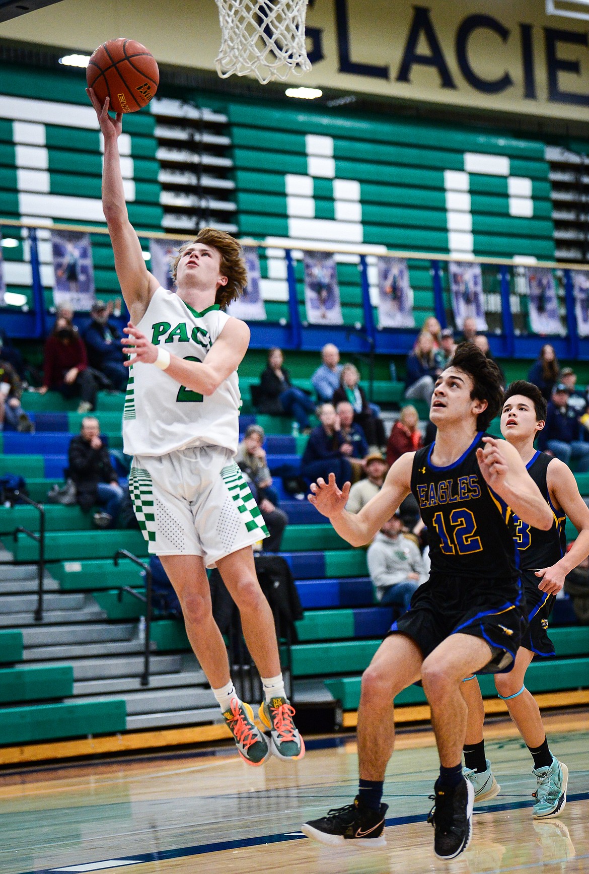 Glacier's Connor Sullivan (2) lays in two points ahead of Missoula Big Sky's Shane Shepherd (12) at Glacier High School on Tuesday, Jan. 25. (Casey Kreider/Daily Inter Lake)
