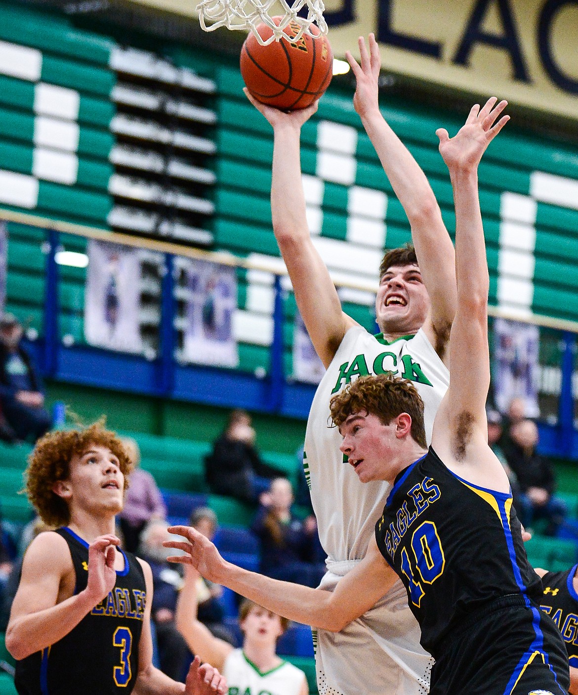 Glacier's Noah Dowler looks to shoot under the basket against MIssoula Big Sky's Tre Reed (3) and Caden Bateman (10) at Glacier High School on Tuesday, Jan. 25. (Casey Kreider/Daily Inter Lake)