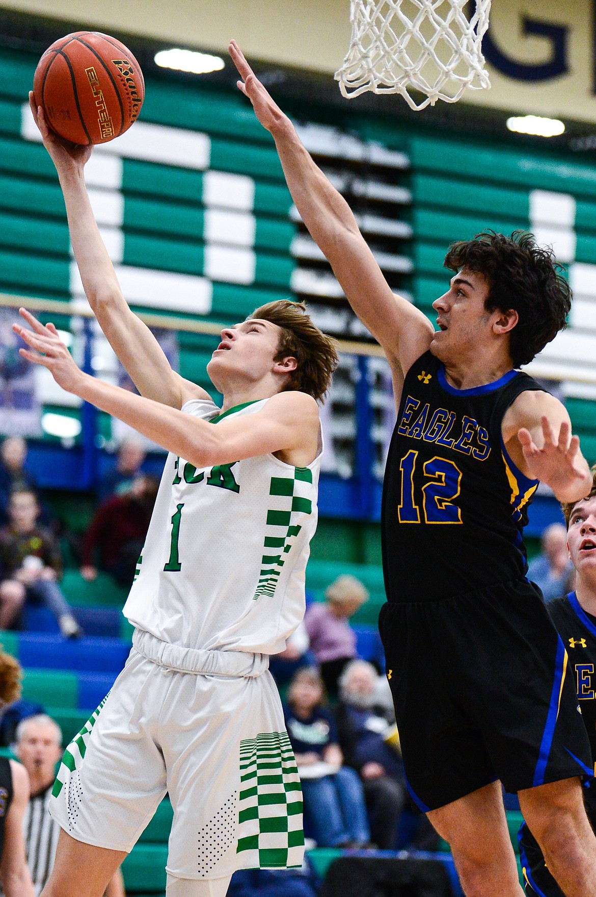 Glacier's John Pyron (1) gets to the basket past Missoula Big Sky's Shane Shepherd (12) at Glacier High School on Tuesday, Jan. 25. (Casey Kreider/Daily Inter Lake)