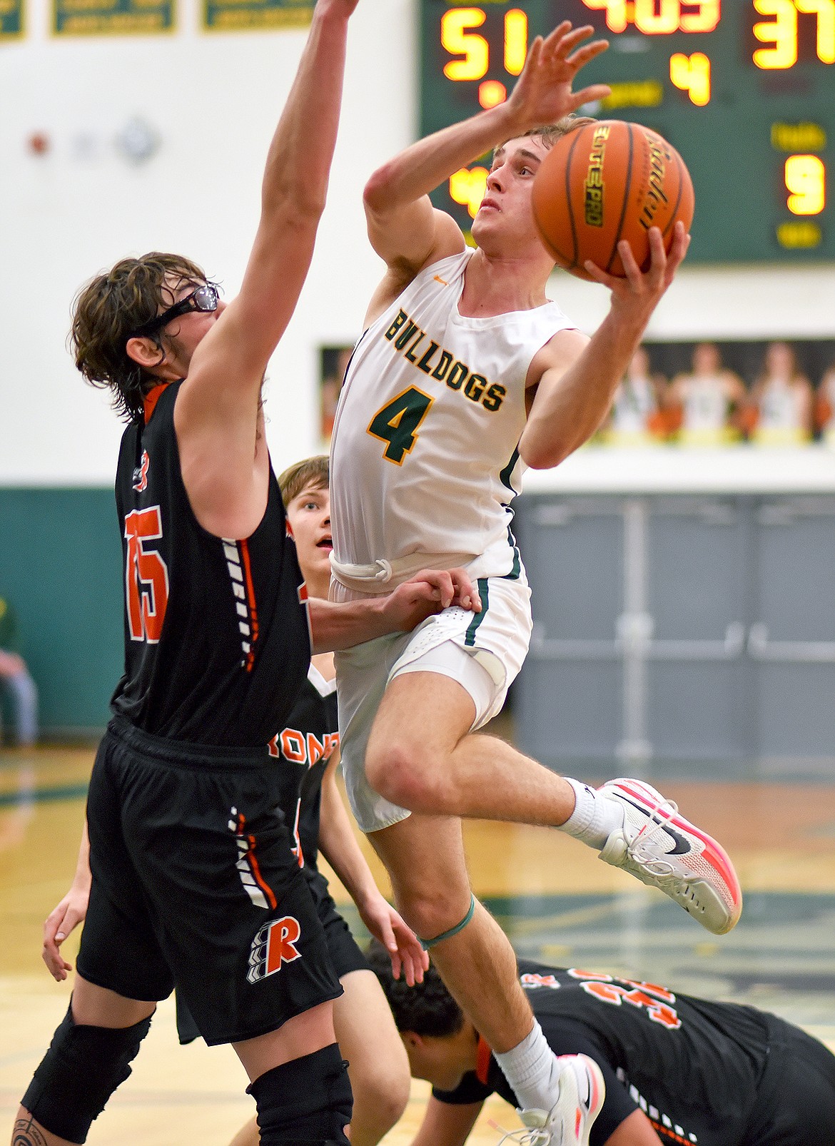 Whitefish senior Bodie Smith takes a shot over Ronan's Payton Cates on Friday night in Whitefish. (Whitney England/Whitefish Pilot)