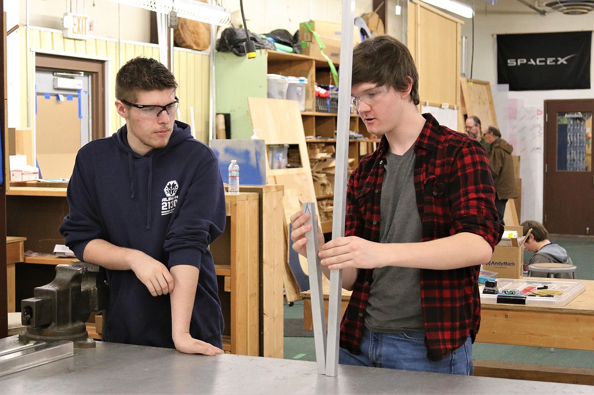 Seth Tuma (left) and Alex Stella problem solve the design of the robot for the next competition.