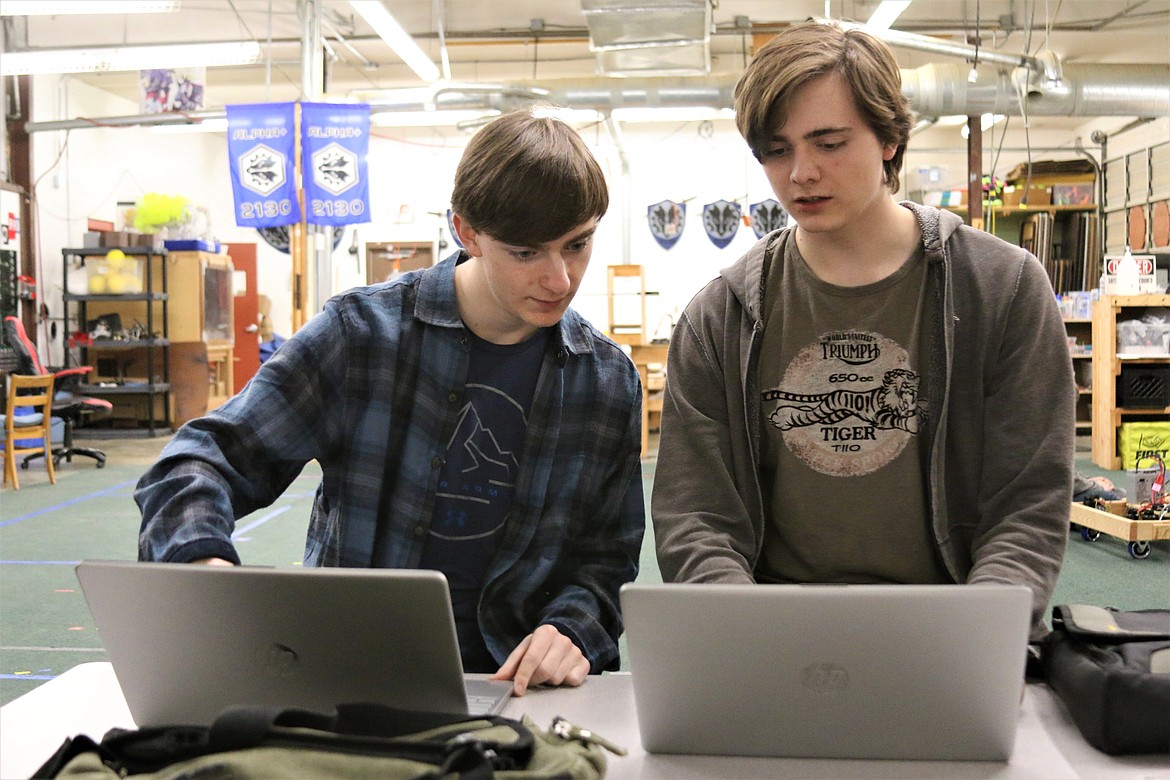 Thomas Hubbell (left) and Cory Clairmont work on programming for the next robotics competition.