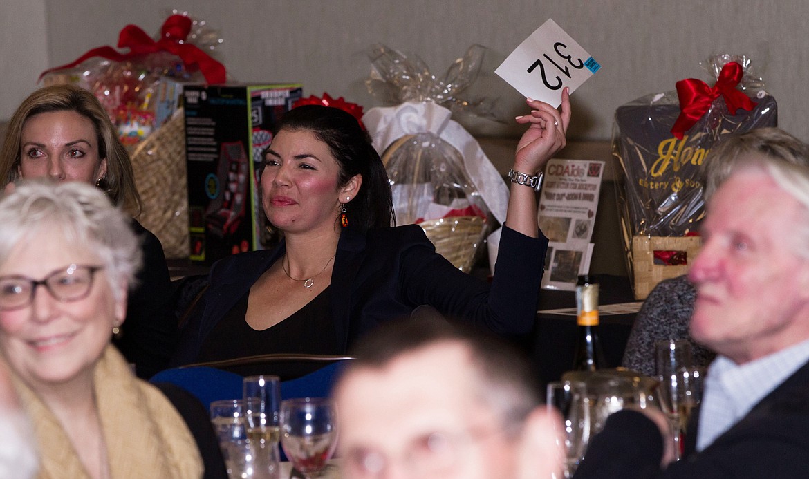 Renee Bordelon raises an auction paddle during the 2020 Care Affair event in The Coeur d'Alene Resort. The fourth annual Care Affair will be Feb. 10.