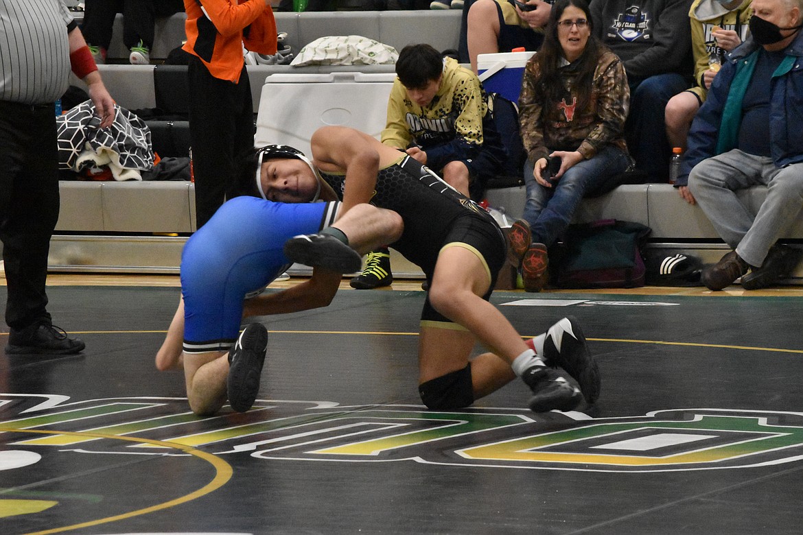 A Royal High School wrestler grabs a Warden High School wrestler by the leg at the Quincy Mat Animal Invitational on Saturday.