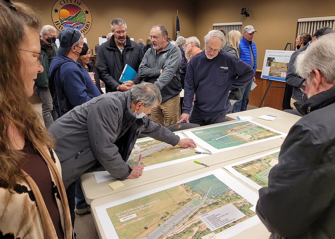 Bud Van Natta places a comment on a map Wednesday during the Honeysuckle Beach and Boat Launch Study Open House.