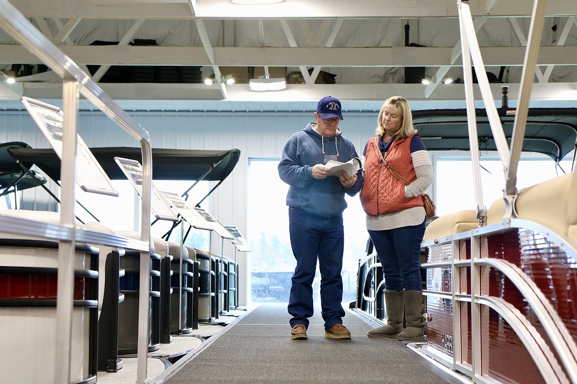 Mike and Vickie Linch of Priest River check out boats at the Coeur d'Alene Boat Expo at the Hagadone Marine Center on Wednesday. HANNAH NEFF/Press