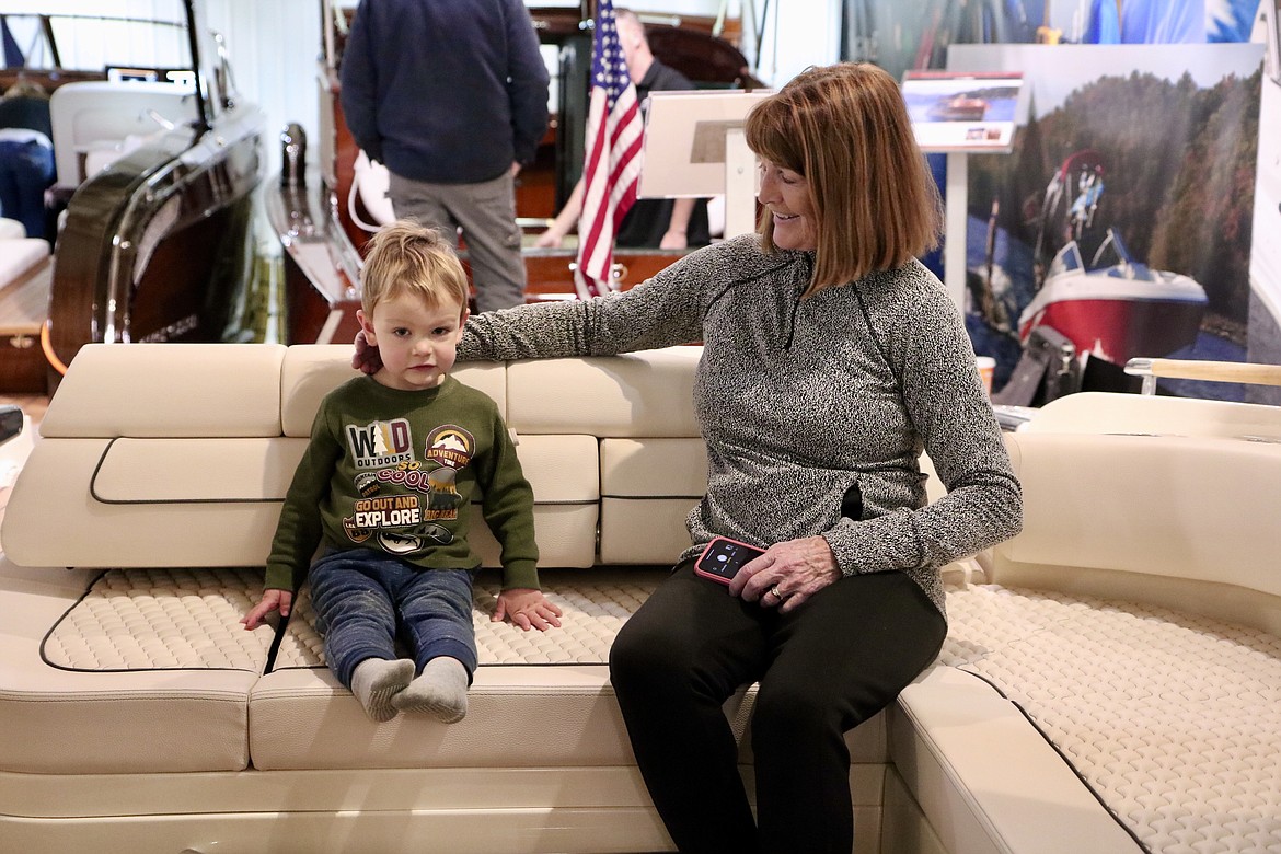 J. Ashley and her grandson check out a boat at the Hagadone Marine Center on Wednesday during the third annual Coeur d'Alene Boat Expo. HANNAH NEFF/Press