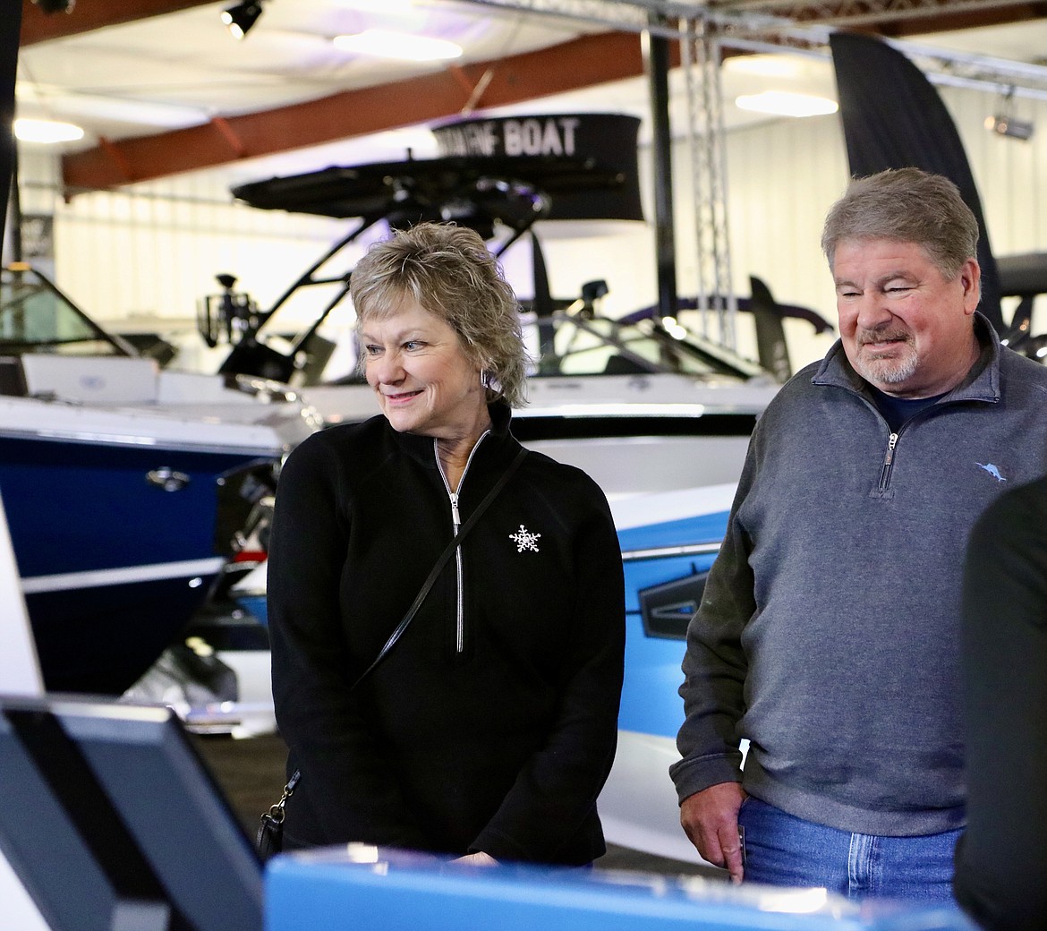 Kathy and Mike of Tri-Cities, Wash., check out boats on Wednesday at the third annual Coeur d'Alene Boat Expo at the Hagadone Marine Center. The expo runs through Feb. 5. HANNAH NEFF/Press