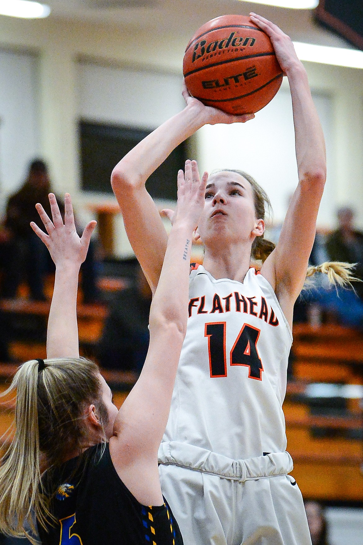 Flathead's Kennedy Moore (14) shoots over Missoula Big Sky's Avari Batt (5) at Flathead High School on Thursday, Jan. 27. (Casey Kreider/Daily Inter Lake)