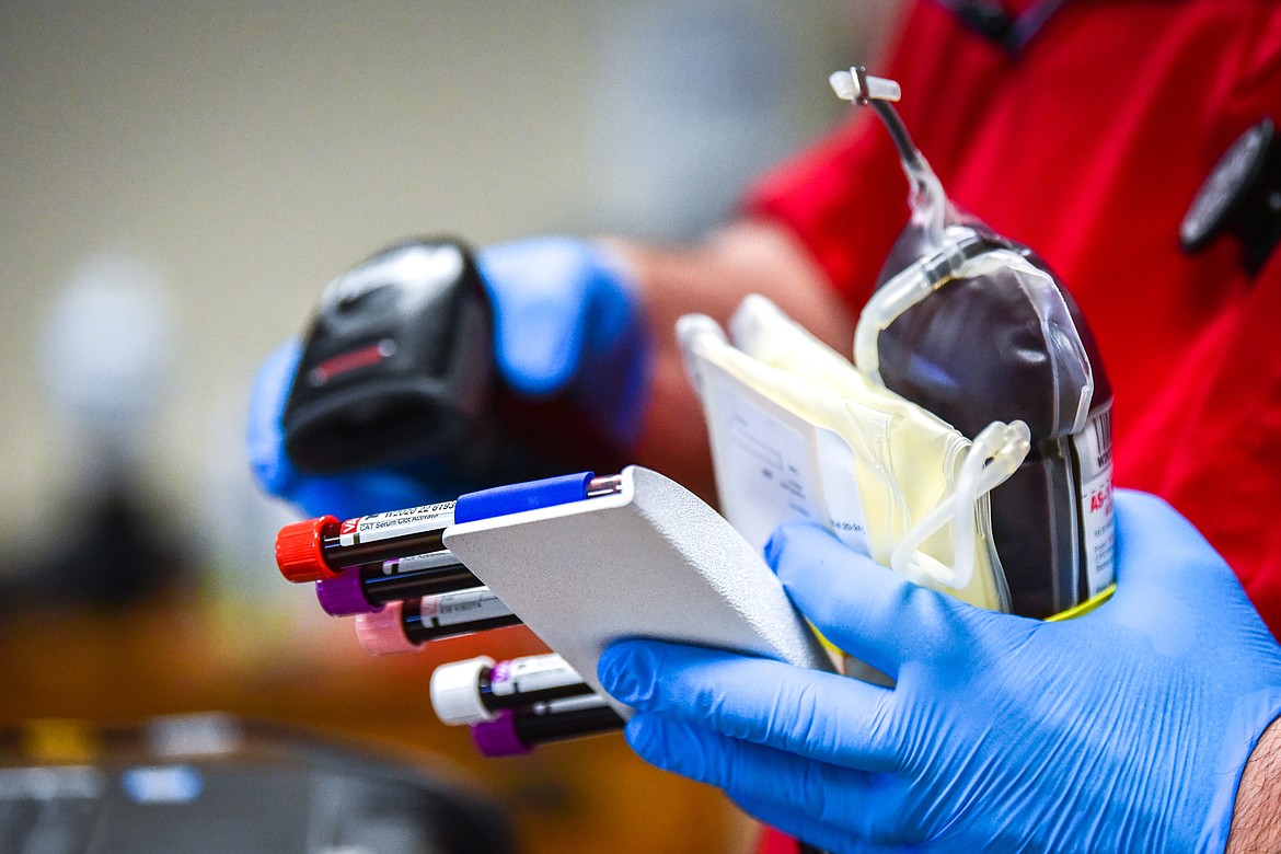 Phlebotomist Shannon Duggan processes collected units of blood for transport at an American Red Cross blood drive at the Flathead National Forest office in Kalispell on Thursday, Jan. 27. (Casey Kreider/Daily Inter Lake)